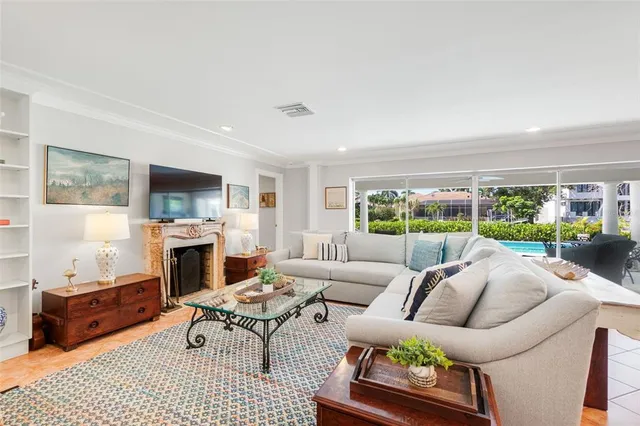 a living room with furniture a fireplace and a flat screen tv