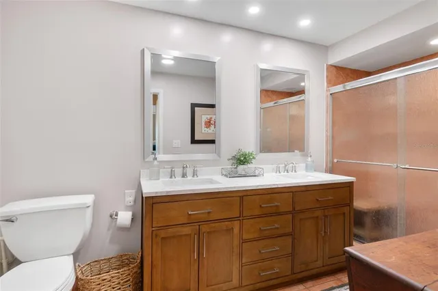 a bathroom with a toilet a sink and mirror