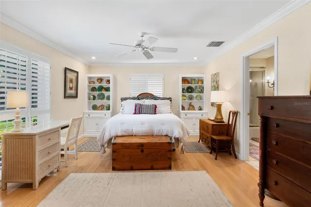 a spacious bedroom with a bed and a dresser