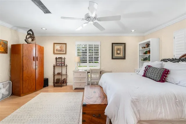 a bedroom with a large bed and a chandelier