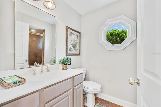 a bathroom with a sink a vanity and a toilet