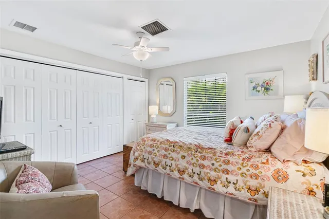 a bedroom with bed and wooden floor