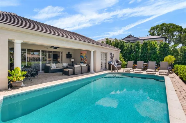 a backyard of a house with table and chairs