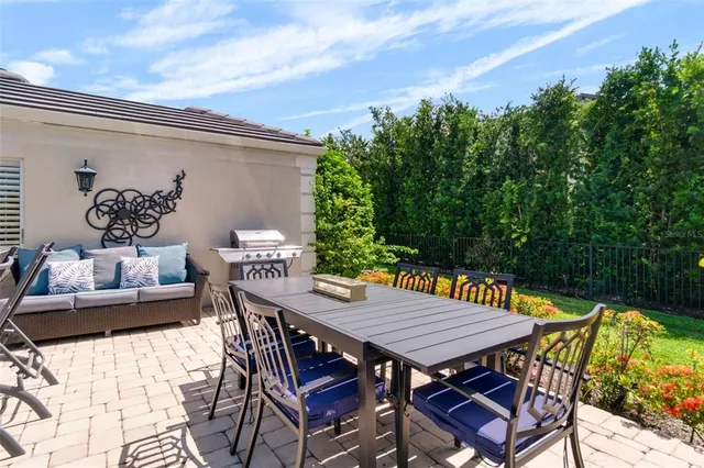 a view of a house with a big yard and potted plants