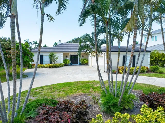 a front view of a house with garden and patio