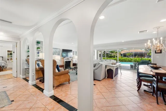 a living room with patio furniture and a large window