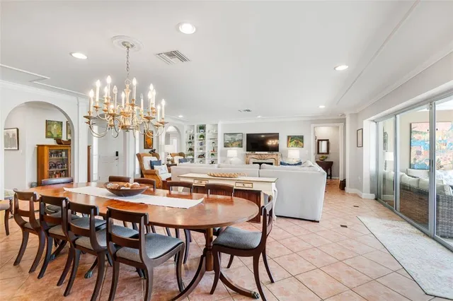 a view of a dining room with furniture and chandelier