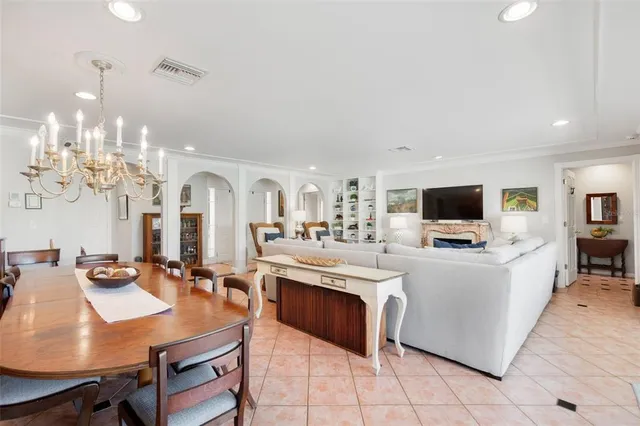 a living room with furniture a flat screen tv and kitchen view