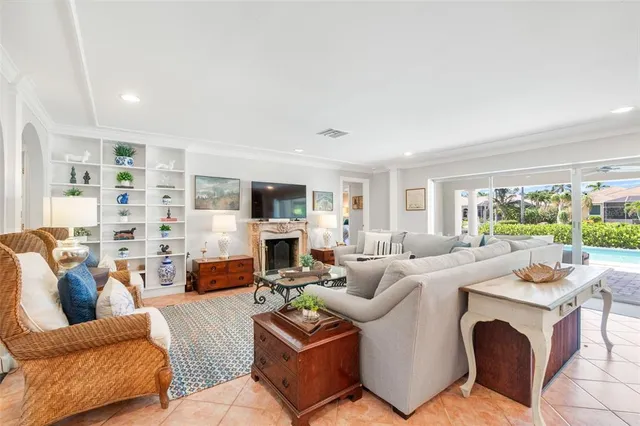 a living room with fireplace furniture and a large window