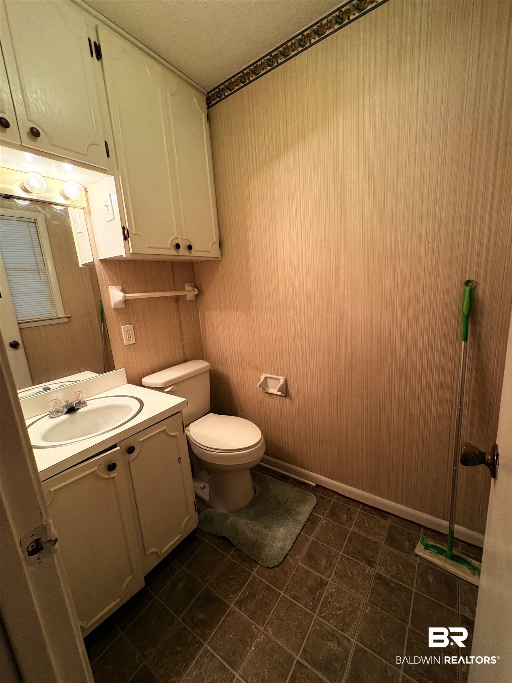 8065 Middle Ring Road Mobile, AL 36619 - Photo 12 of 21 Half bath featuring vanity, toilet, and baseboards