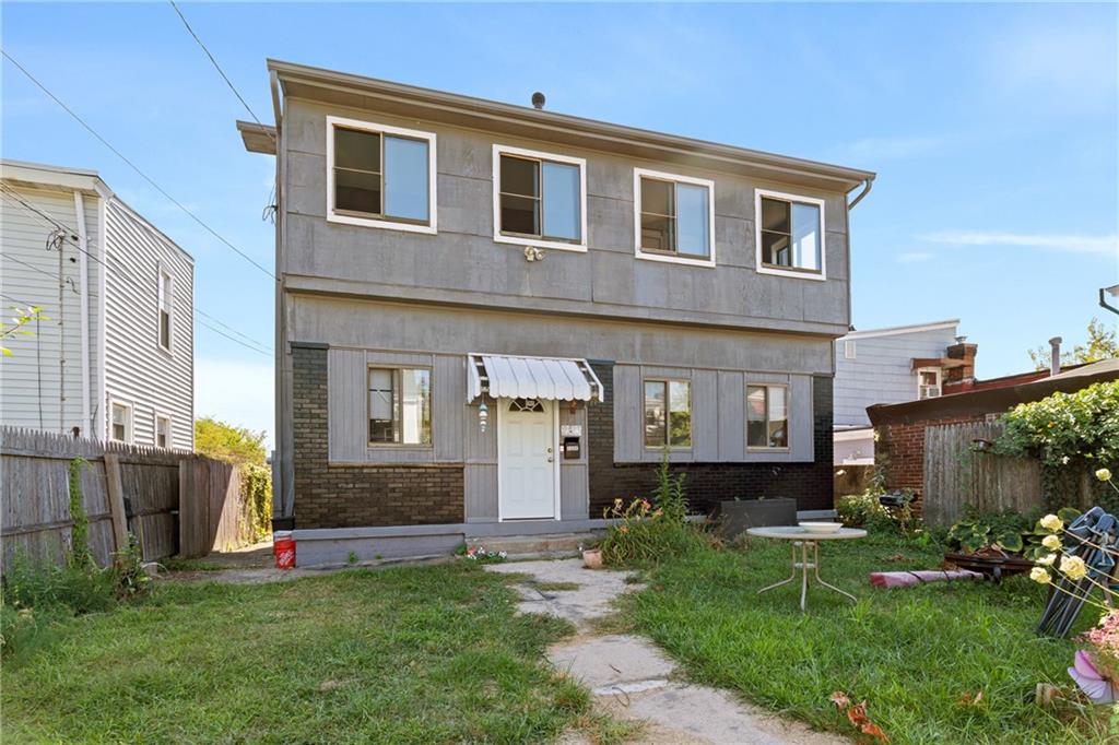2123 Lautner Street Pittsburgh, PA 15212 - Photo 1 of 32 a front view of a house with a yard and outdoor seating