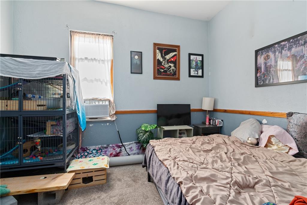 2123 Lautner Street Pittsburgh, PA 15212 - Photo 24 of 32 a bedroom with a bed a couch and dresser