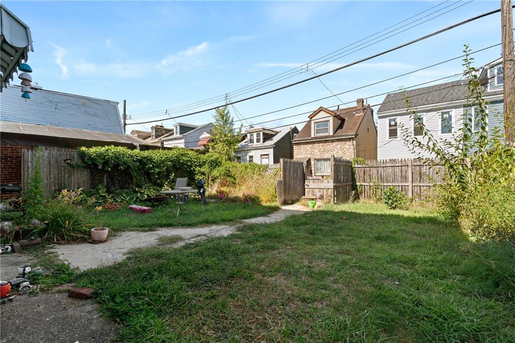 2123 Lautner Street Pittsburgh, PA 15212 - Photo 27 of 32 a front view of a house with a yard and garden