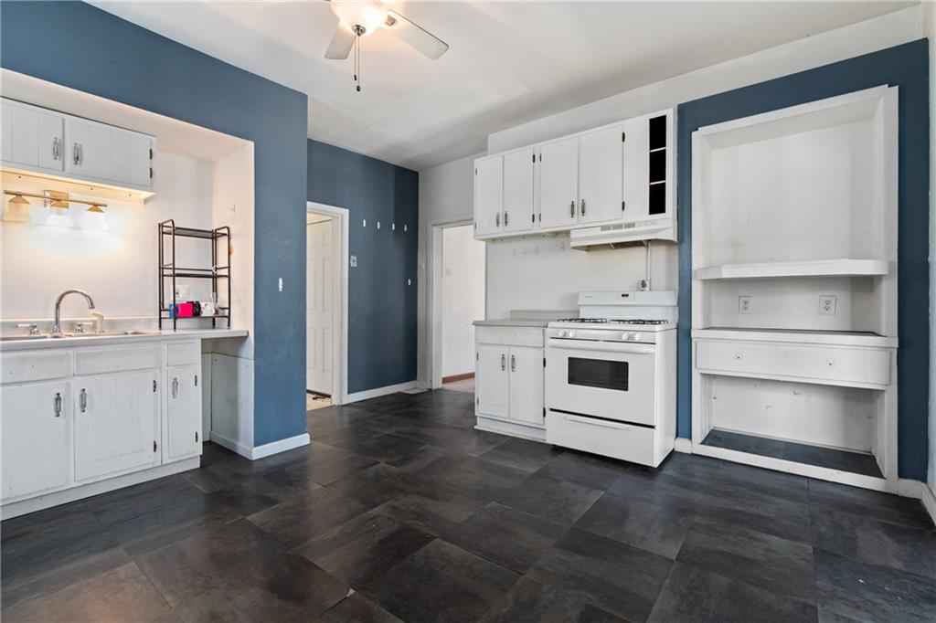2123 Lautner Street Pittsburgh, PA 15212 - Photo 4 of 32 a kitchen with white cabinets and appliances