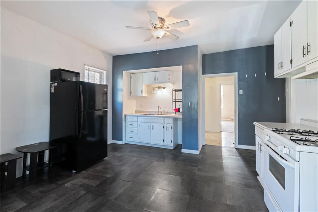 2123 Lautner Street Pittsburgh, PA 15212 - Photo 5 of 32 a kitchen with granite countertop a refrigerator and a stove top oven