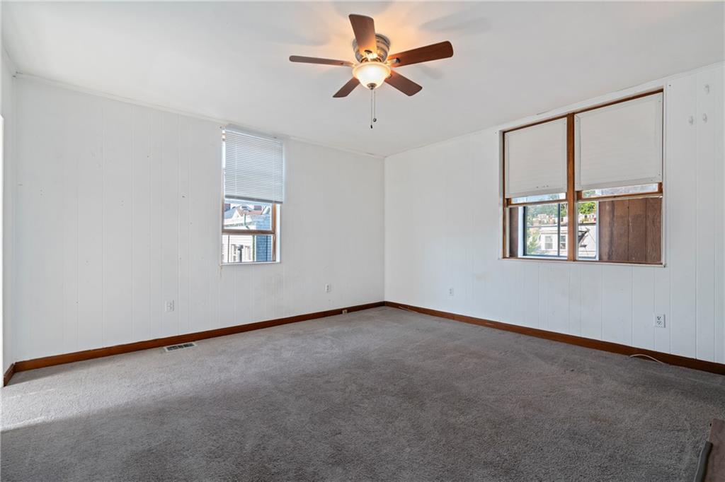 2123 Lautner Street Pittsburgh, PA 15212 - Photo 9 of 32 an empty room with windows and fan