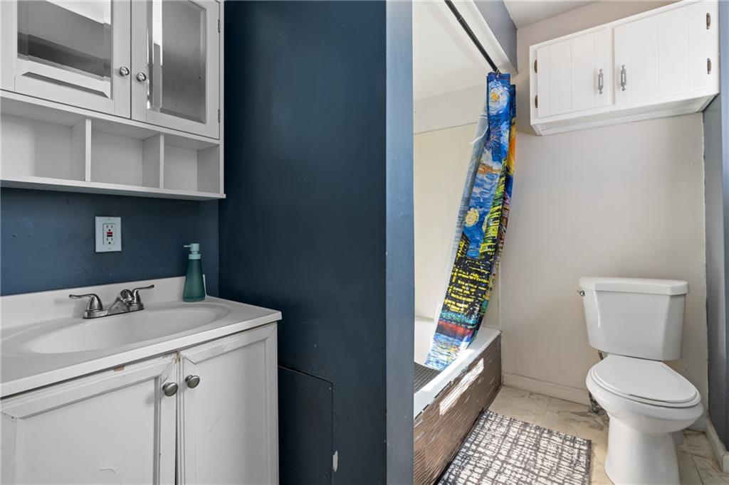 2123 Lautner Street Pittsburgh, PA 15212 - Photo 10 of 32 a bathroom with a sink toilet and window