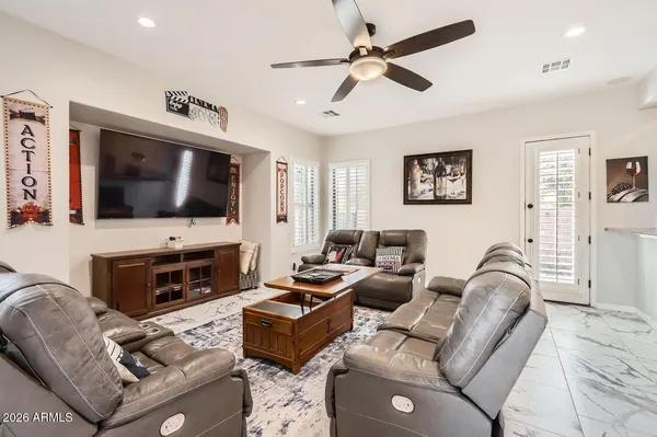 a living room with furniture a flat screen tv and a fireplace