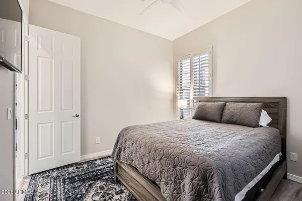 a bedroom with a bed and with window