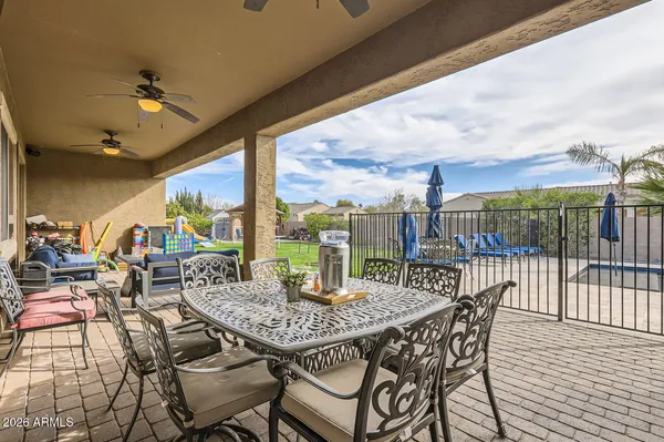 a view of a patio with a table and chairs