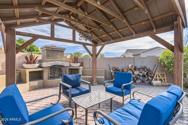 a outdoor living space with furniture a fireplace and a potted plant