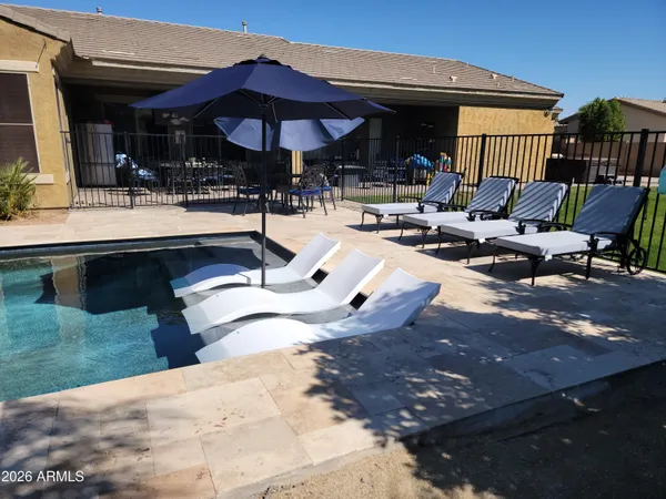 a view of swimming pool with outdoor seating