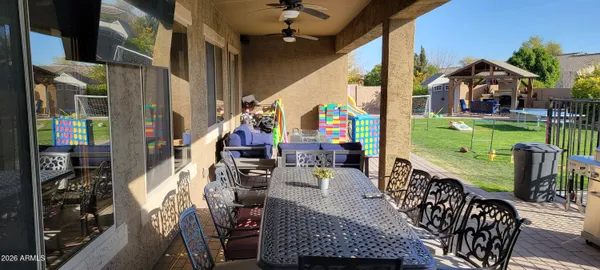 a view of an outdoor dining space with a table and chairs