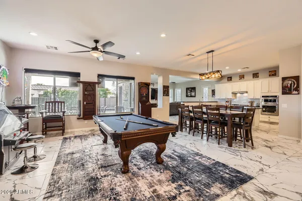 a outdoor space with lots of tables a large window and chairs