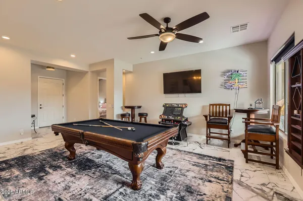 a living room with furniture a flat screen tv and a window