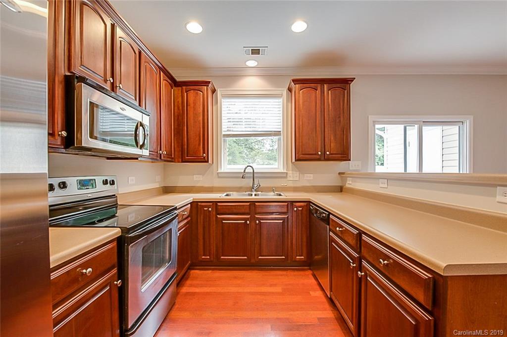 234 River Clay Road Fort Mill, SC 29708 - Photo 2 of 15 a kitchen with stainless steel appliances granite countertop stove a sink dishwasher and cabinets with wooden floor