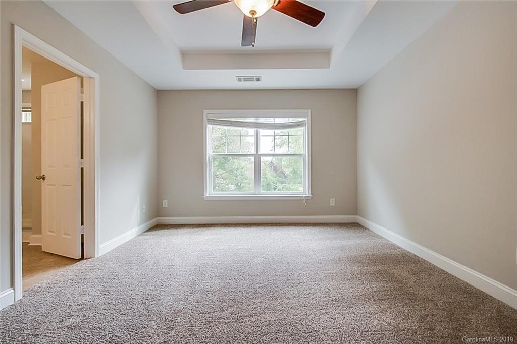 234 River Clay Road Fort Mill, SC 29708 - Photo 8 of 15 an empty room with a window and a chandelier fan