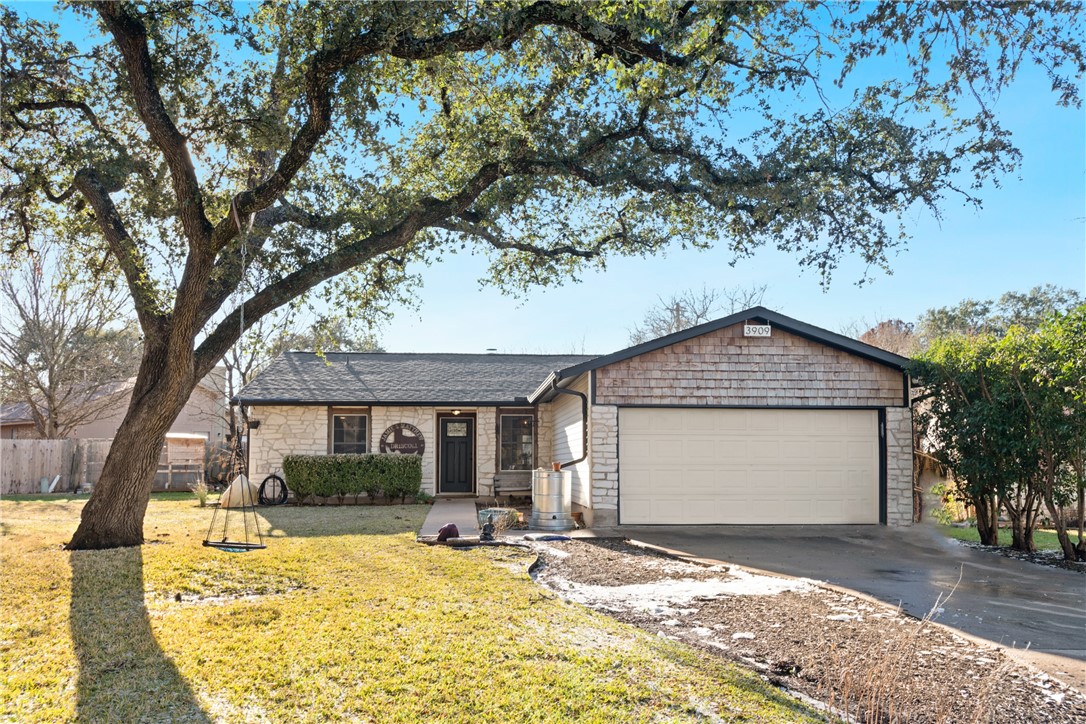 a front view of a house with a garden and patio