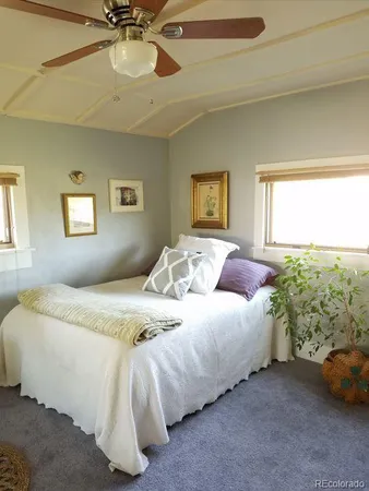 a bedroom with a bed lamp and a window