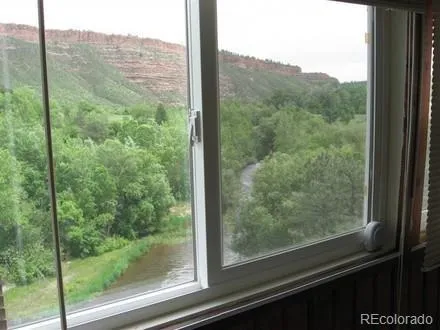 a view of a glass door and a window