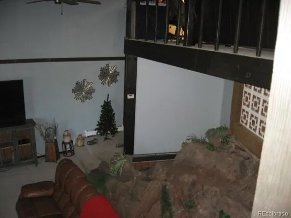 a bedroom with a bed and painting on the wall