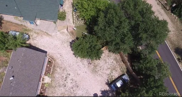 an aerial view of a house with a yard and lake view