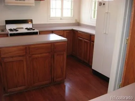 a kitchen with a sink cabinets and a window