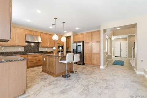 a kitchen with stainless steel appliances granite countertop a stove a sink a microwave and a refrigerator