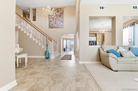 a living room with furniture and a dining table