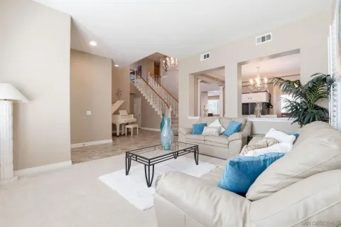 a living room with furniture and a stairs
