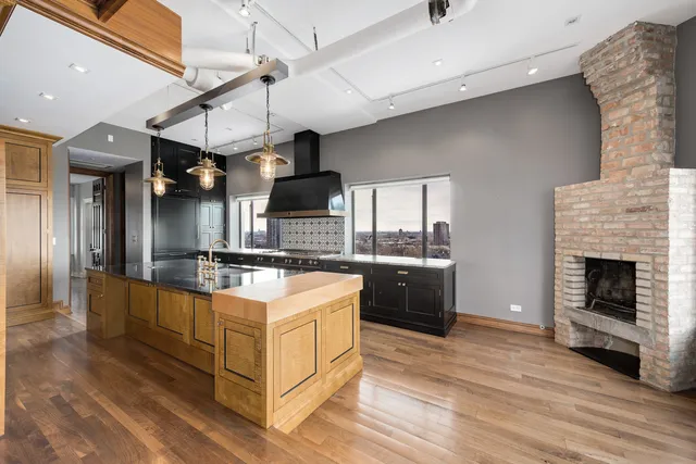 a large kitchen with stainless steel appliances granite countertop a stove and a sink
