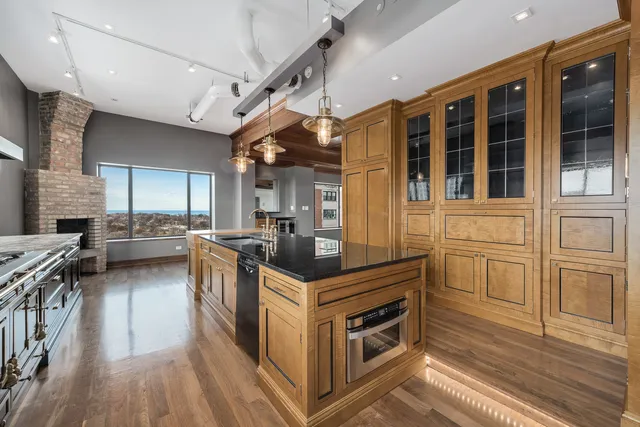 a kitchen with stainless steel appliances granite countertop a stove and a refrigerator