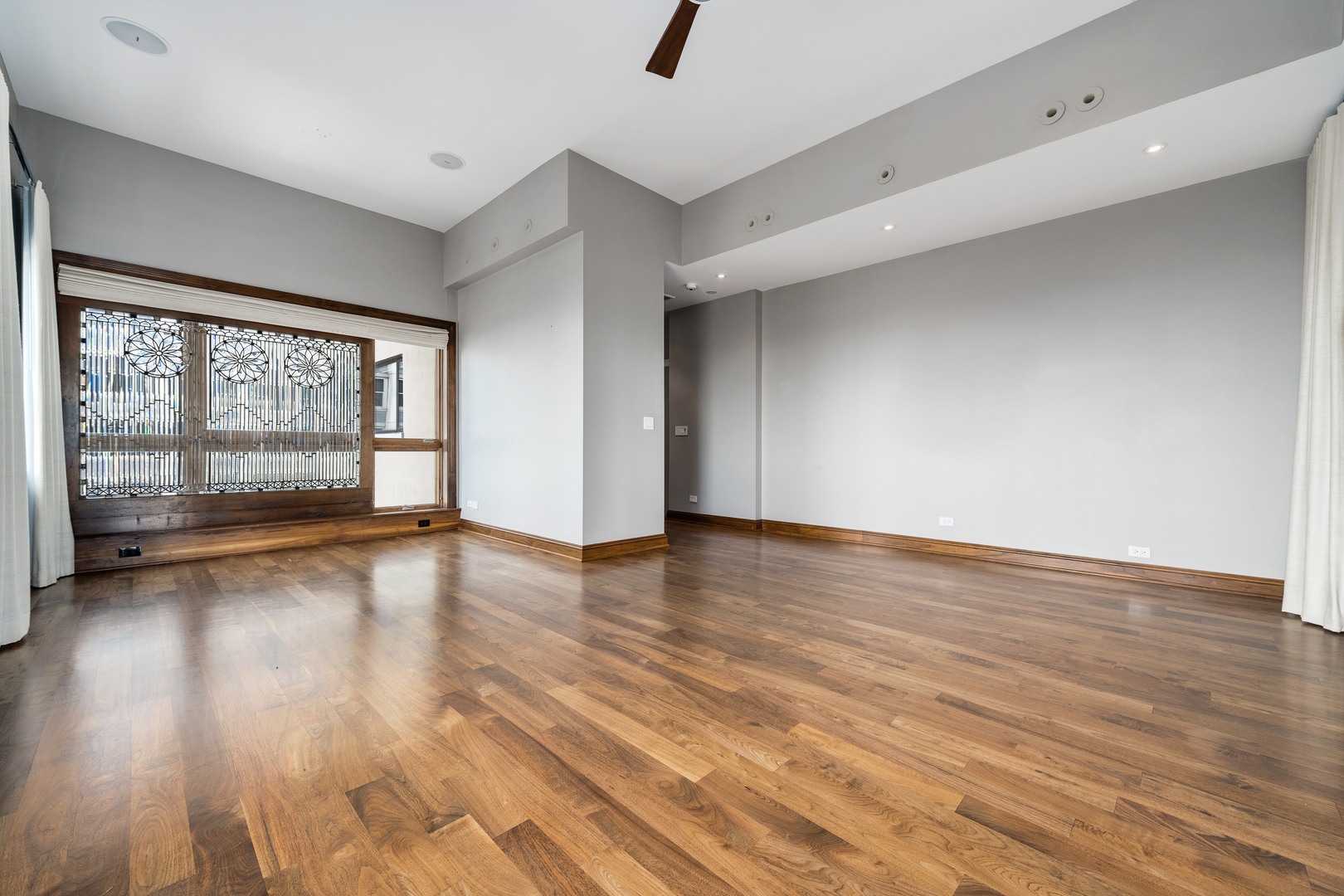 707 West Jr Terrace, Unit PH12 Chicago, IL 60613 - Photo 16 of 41 an empty room with wooden floor and windows