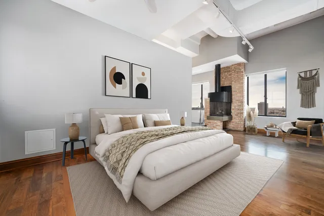 a spacious bedroom with a bed and lamp