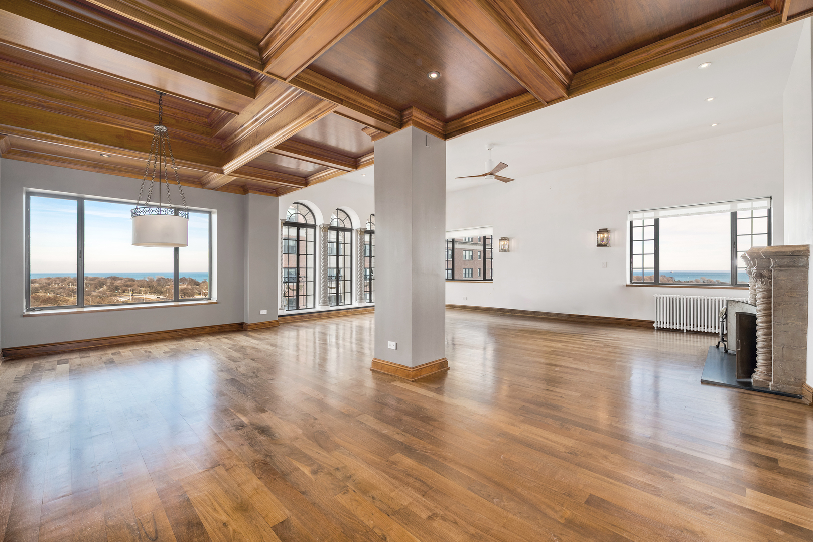 707 West Jr Terrace, Unit PH12 Chicago, IL 60613 - Photo 2 of 41 a view of an empty room with wooden floor and a window