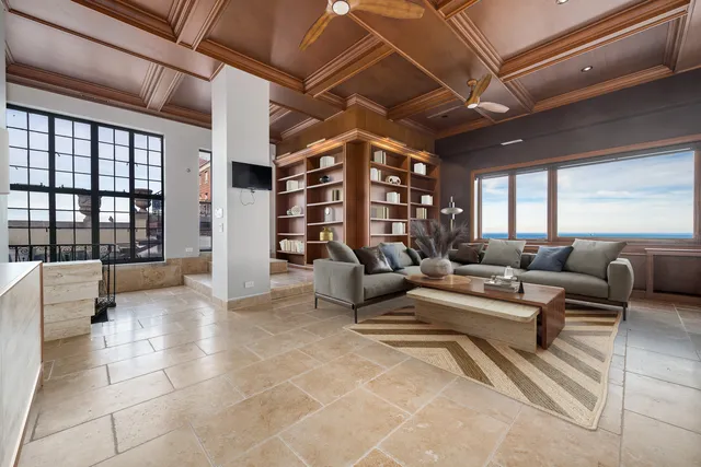 a living room with furniture and a chandelier