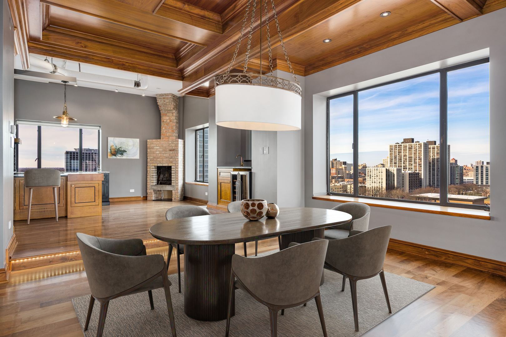 707 West Jr Terrace, Unit PH12 Chicago, IL 60613 - Photo 8 of 41 a dining room with furniture a chandelier and wooden floor