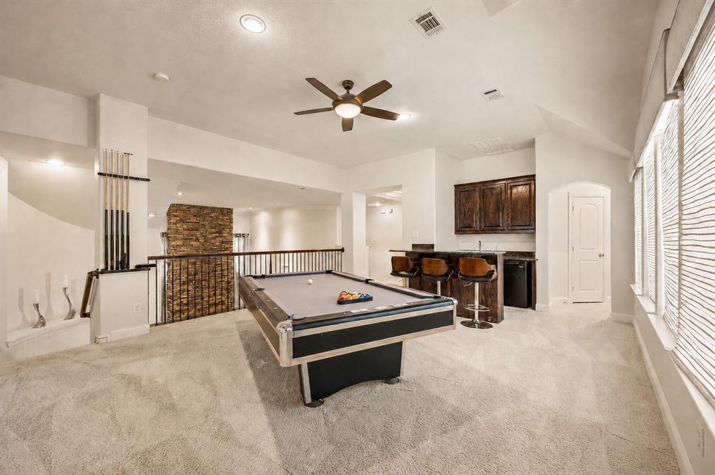 1521 Newton Ranch Road Keller, TX 76248 - Photo 27 of 40 Spacious upstairs area featuring a built-in wet bar with dark wood cabinetry, a ceiling fan, and recessed lighting