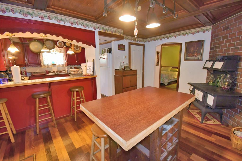 760 McClellan Road Frostproof, FL 33843 - Photo 21 of 72 a kitchen with stainless steel appliances granite countertop a sink dishwasher and a refrigerator with wooden floor
