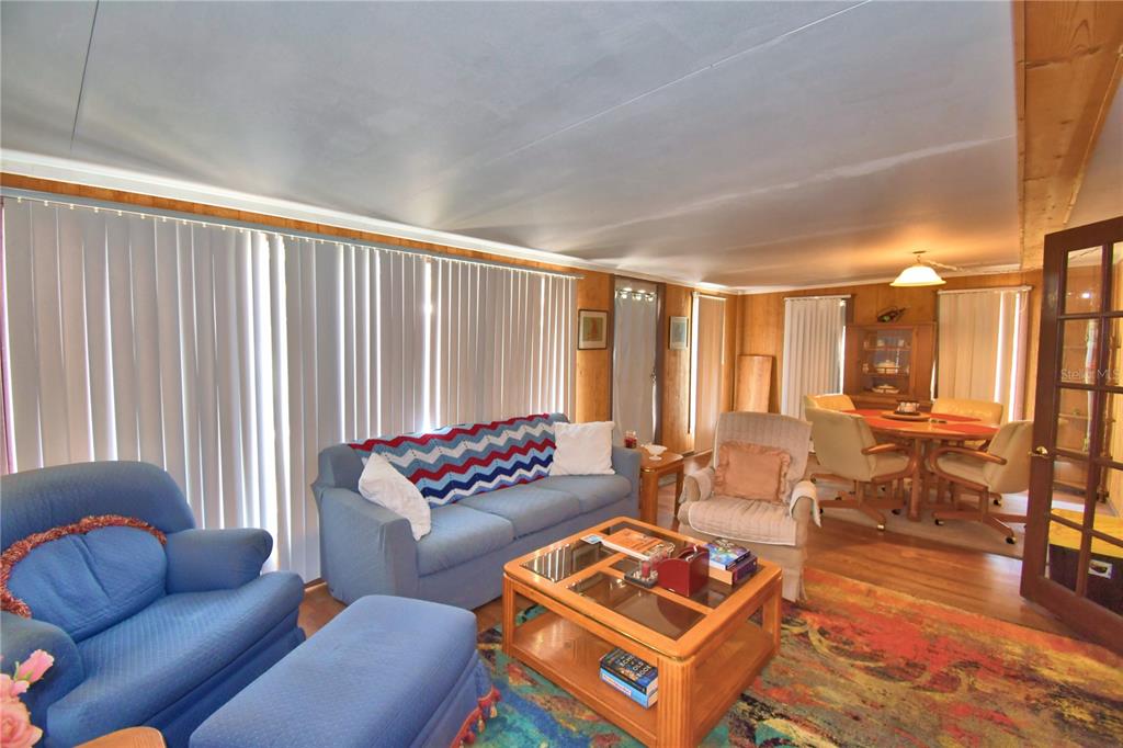 760 McClellan Road Frostproof, FL 33843 - Photo 27 of 72 a living room with furniture and a floor to ceiling window
